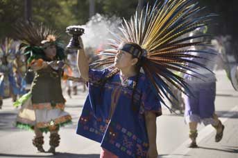 aztec dancer holding smoking incense